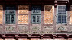 Detailed facade of a historic timber-framed building in Bleckede, Germany, featuring ornate carvings.