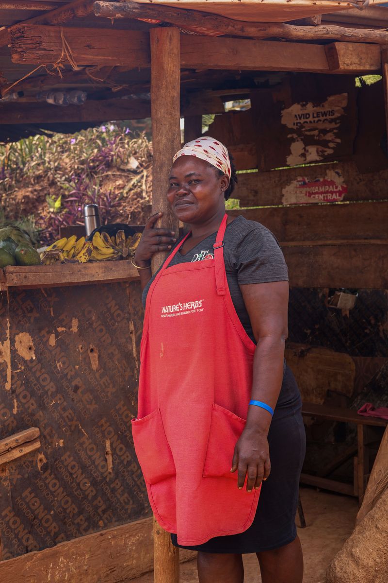 Small-business owner standing in her market stall in Kampala, Uganda