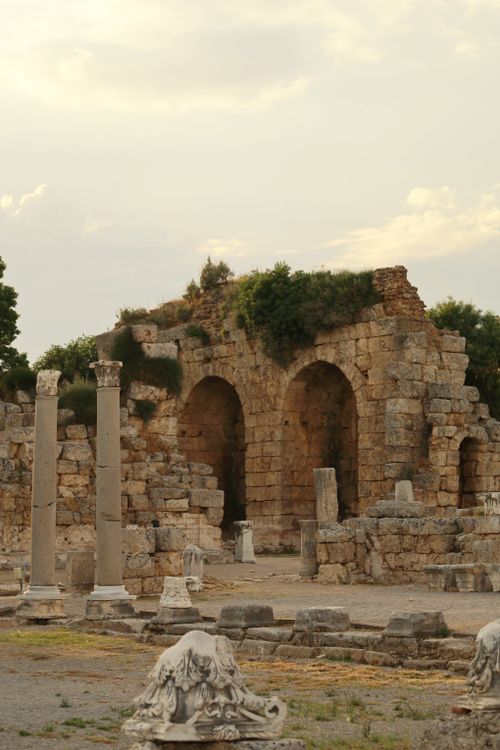 Free Explore the captivating ancient Roman ruins featuring stone arches and scattered columns amidst a serene landscape. Stock Photo
