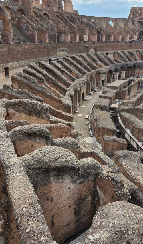Free A detailed view of the ancient architecture within the Colosseum, Rome. Stock Photo