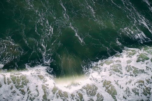 Free Stunning aerial shot of ocean waves crashing on the shore in Malaysia. Stock Photo