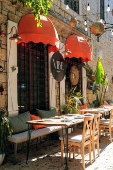 Cozy outdoor café with red awnings and elegant decor, perfect for a vibrant dining experience.