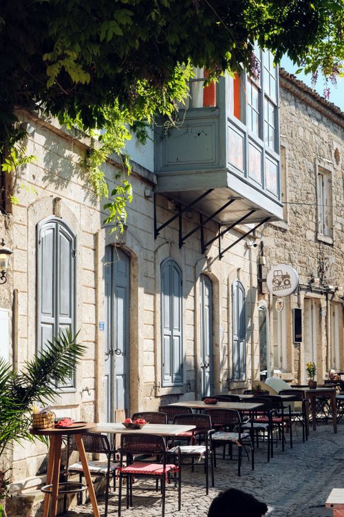 Free Outdoor cafe with rustic charm in a sunny old town street. Stock Photo