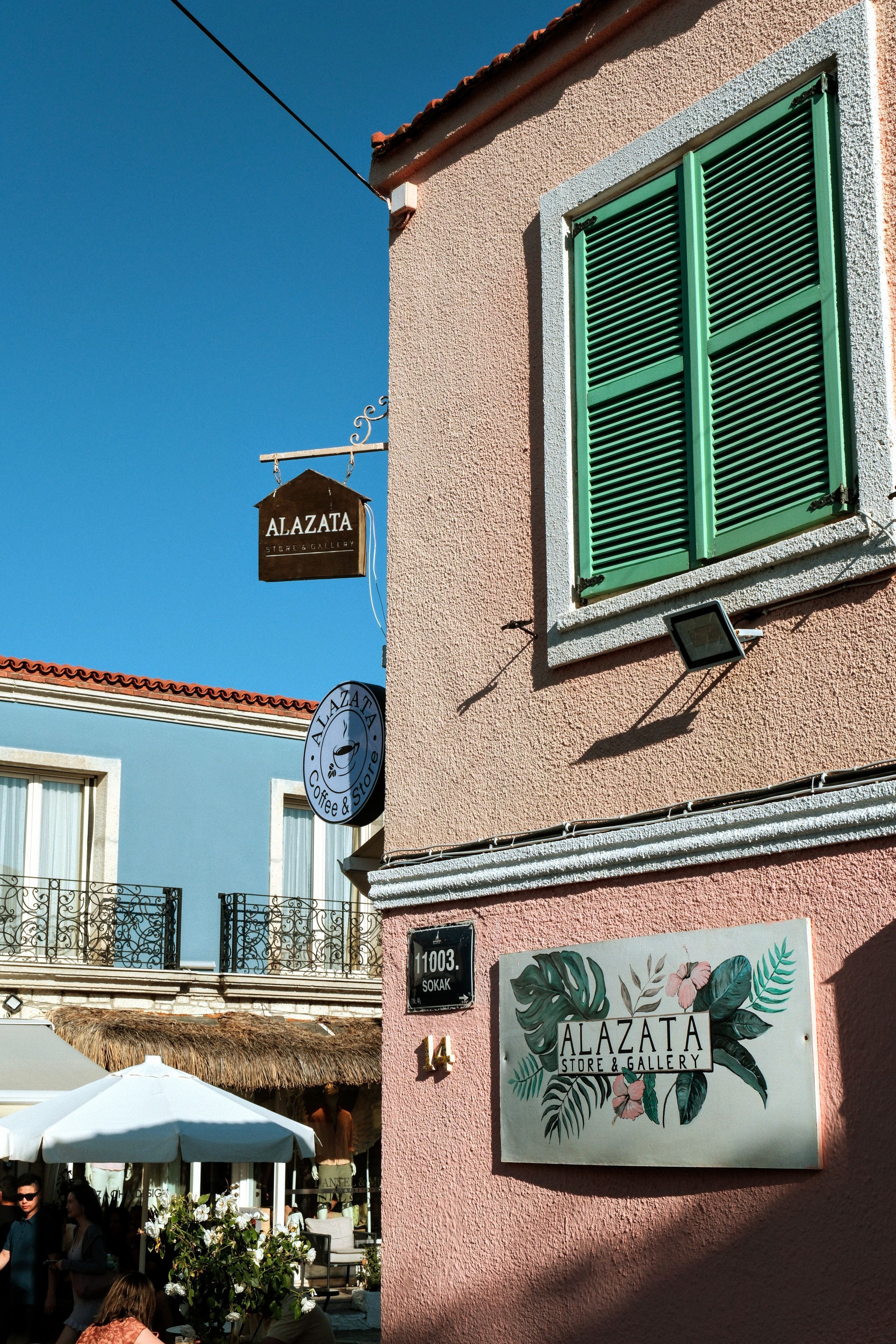 Vibrant street view featuring charming architecture and cafe sign in a European setting.