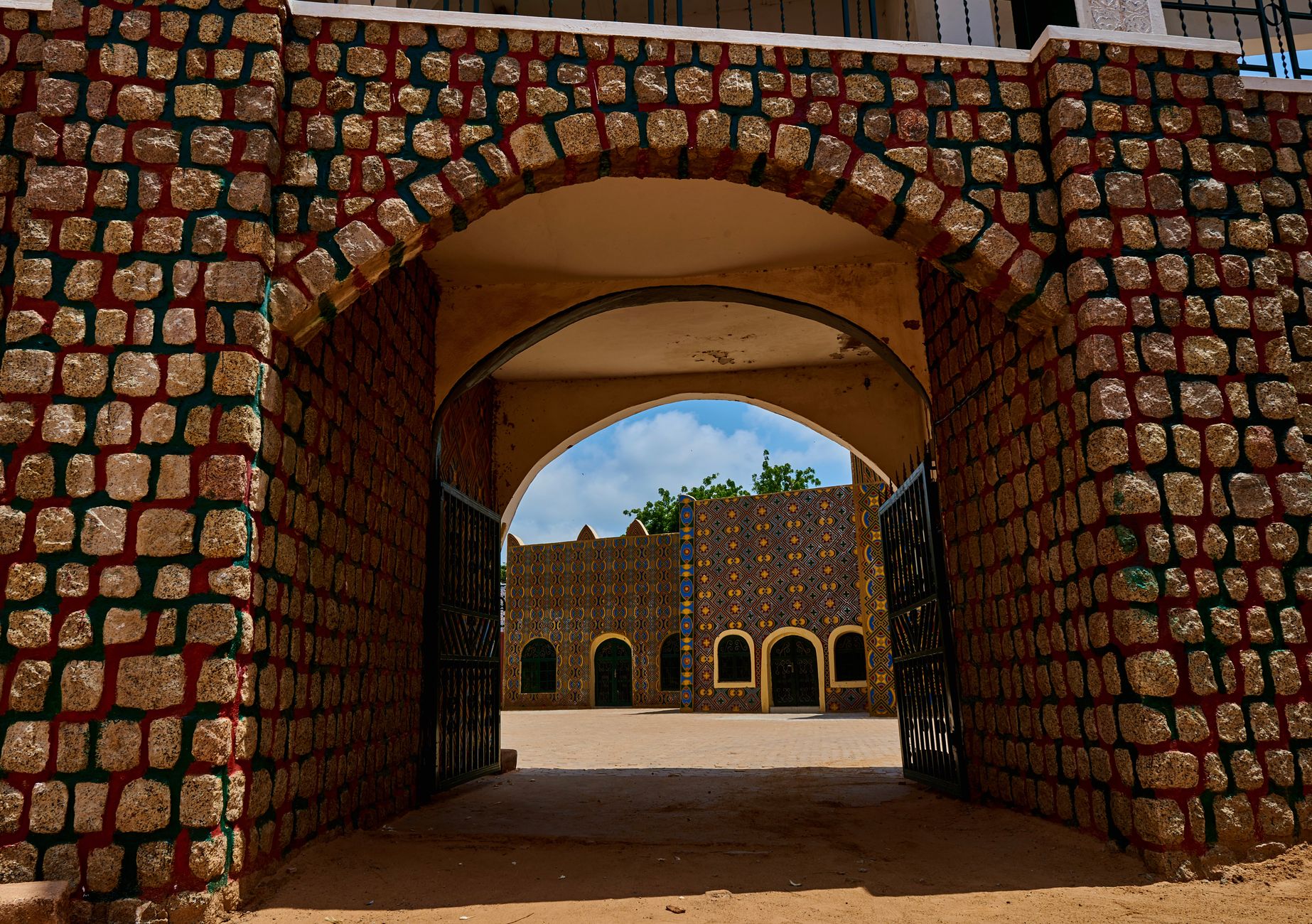 Vibrant traditional architecture at the entrance of a palace in Dutse, Nigeria.