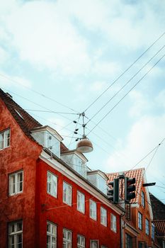 Explore the vibrant architecture of old Copenhagen streets with rustic red brick buildings.