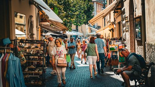 Free A bustling street market in Malcesine, capturing vibrant colors and lively atmosphere. Stock Photo