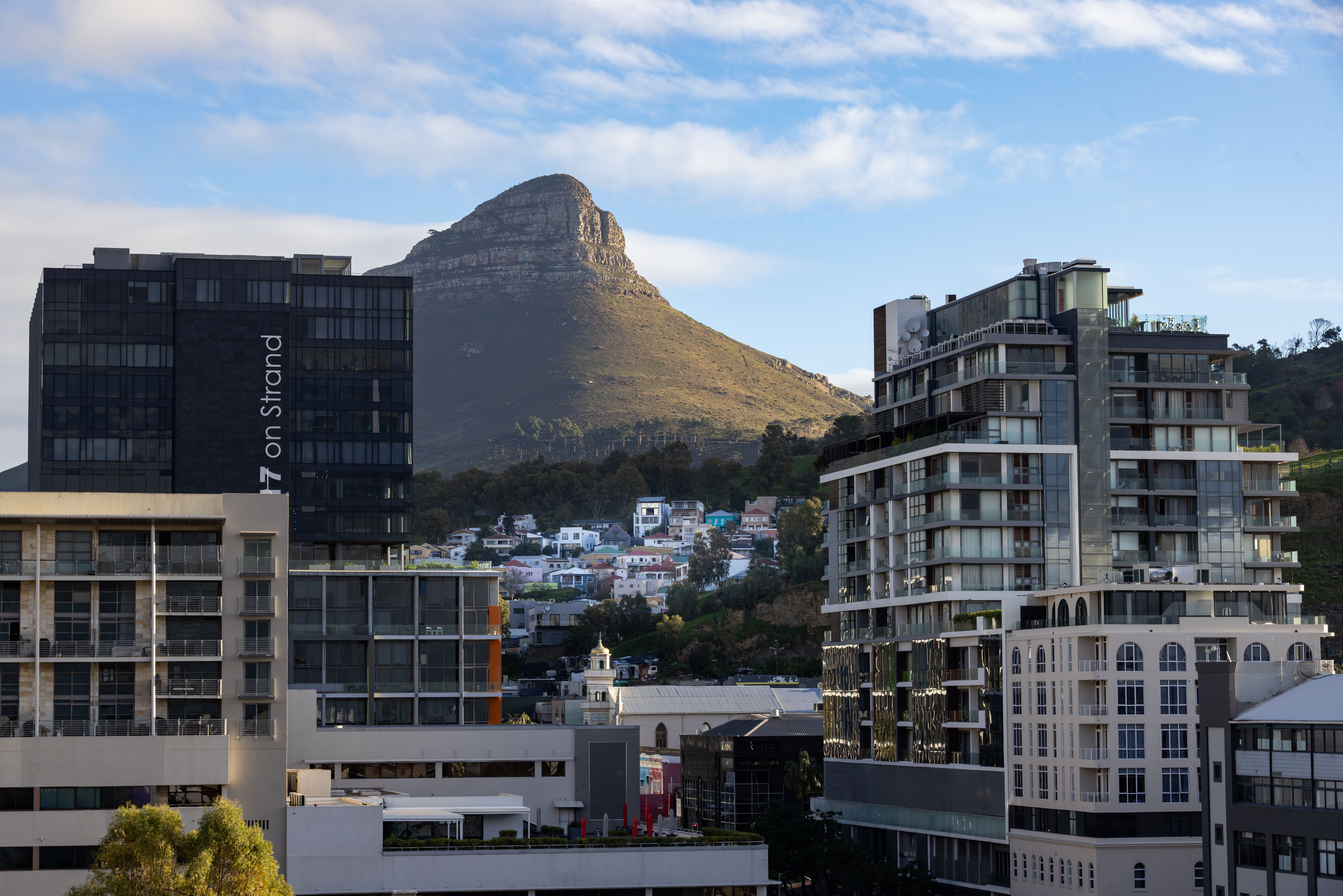 A serviced apartment kitchen and desk in Sea Point with the Atlantic visible through the window