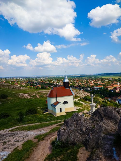 Free Chapel on a hill with a breathtaking view of the countryside and fluffy clouds. Stock Photo