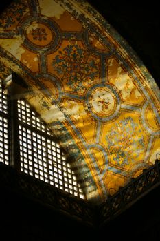 Beautifully detailed dome ceiling in Hagia Sophia with golden motifs and natural lighting.