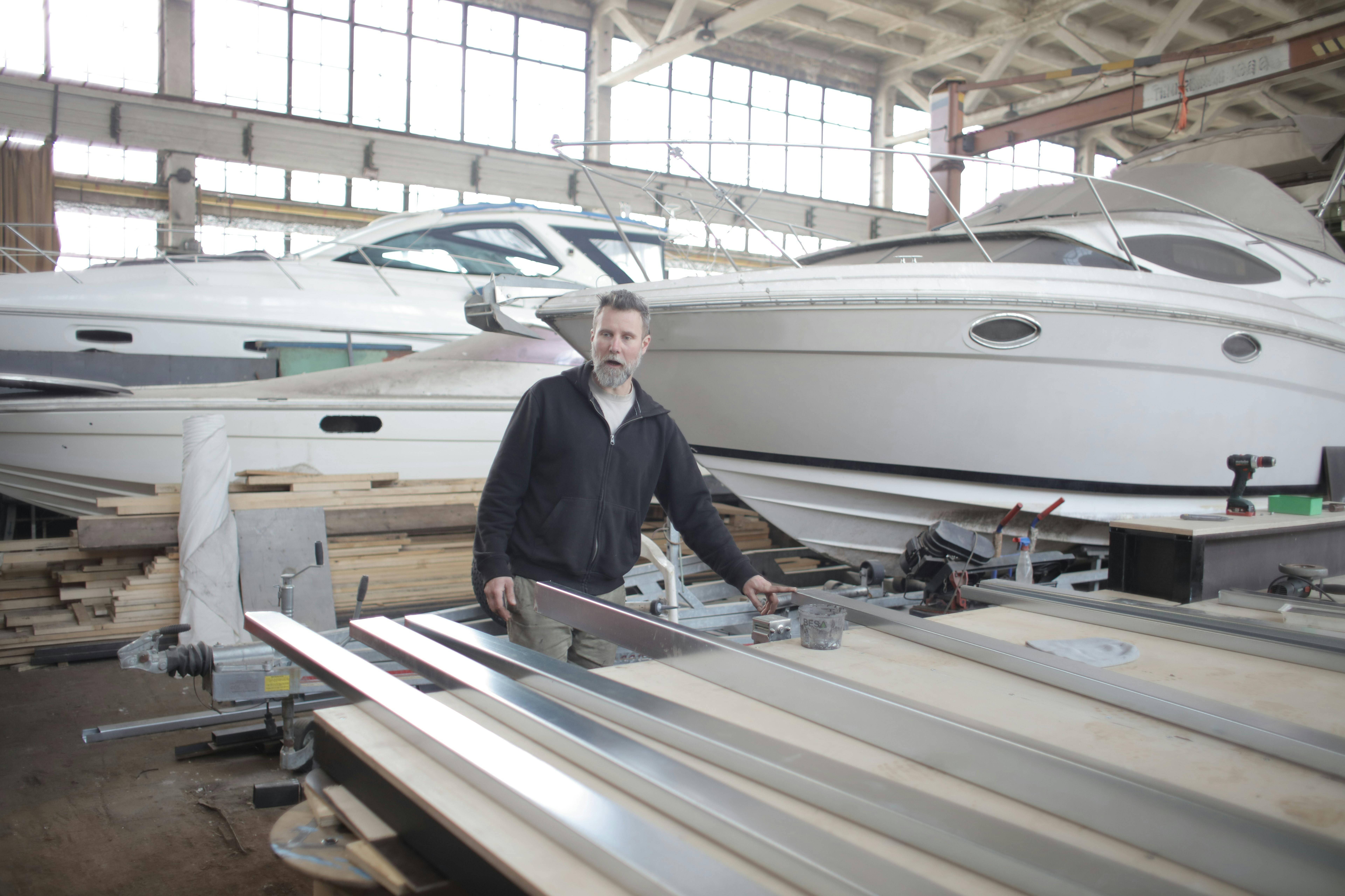 male master in hangar with motor boats