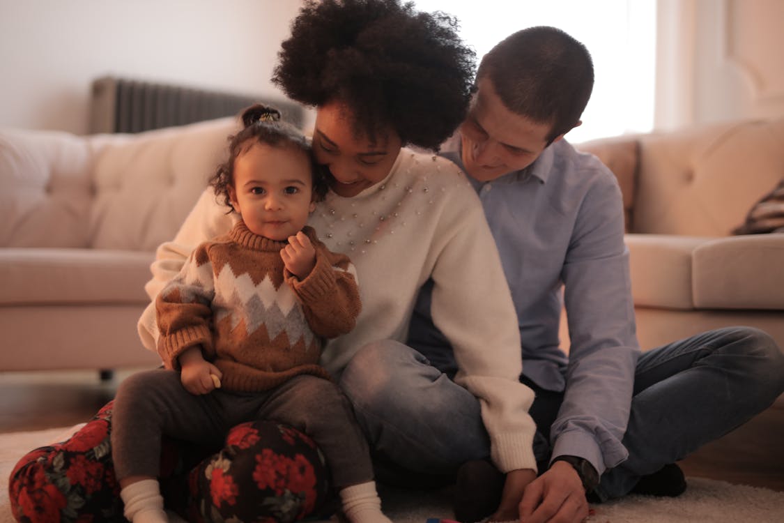 Free Photo of Kid Sitting on Her Mother's Lap Stock Photo