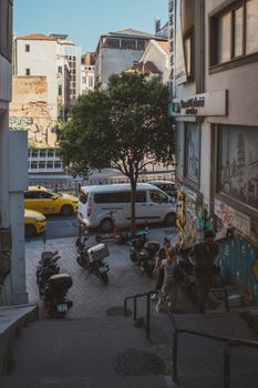 Dynamic city street with motorbikes, taxis, and pedestrians showcasing urban lifestyle.