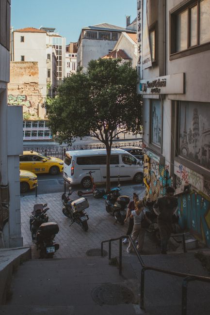 Dynamic city street with motorbikes, taxis, and pedestrians showcasing urban lifestyle.