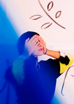 young lady covering eyes with hands
