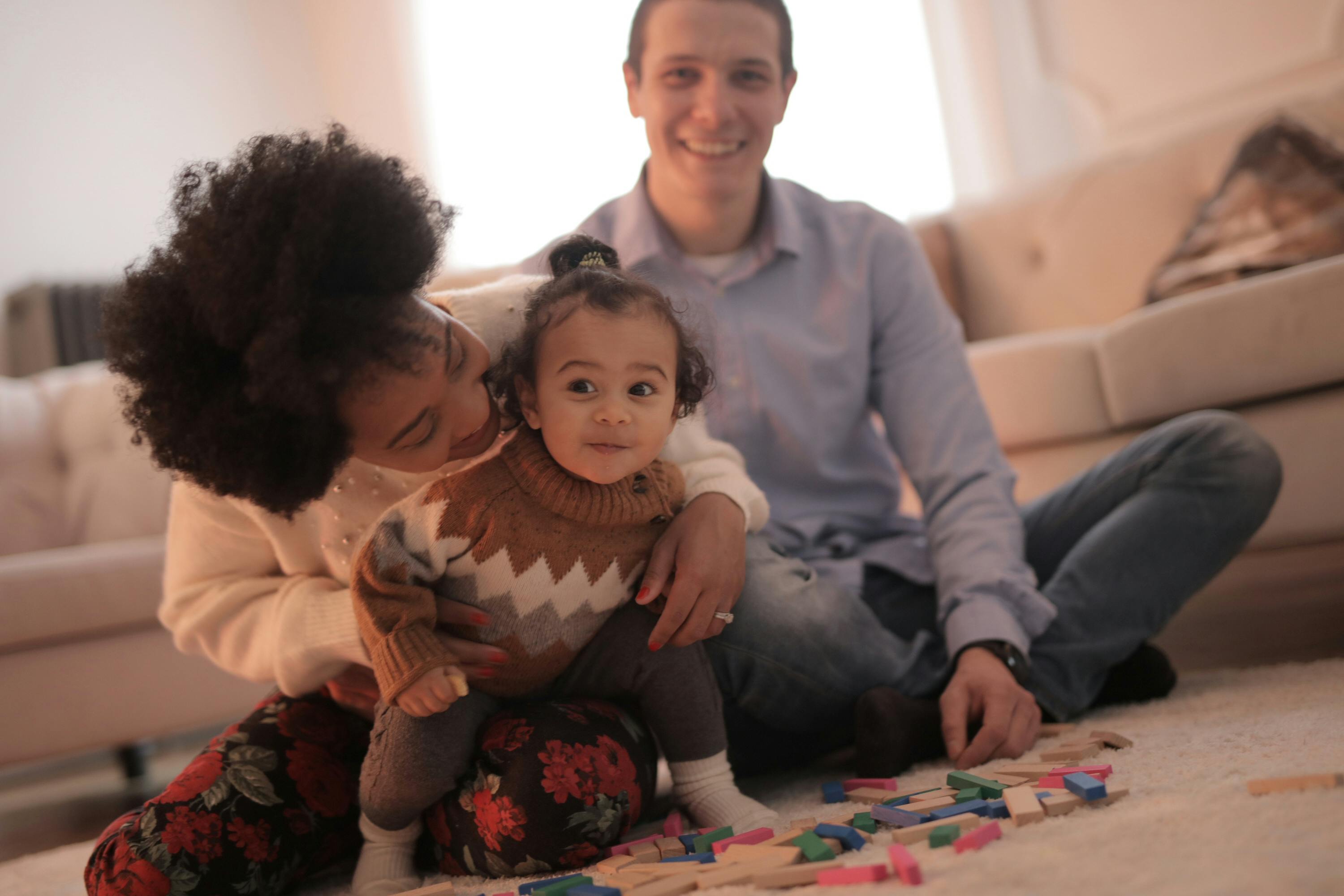 photo of woman playing with her child