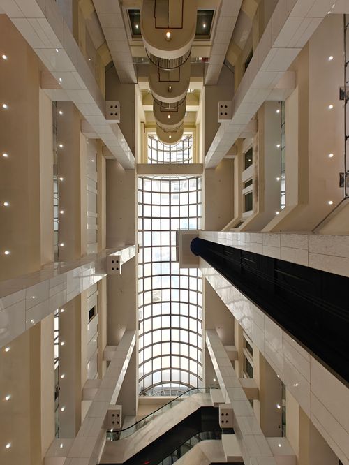 Free Futuristic architecture of an atrium in a Singapore skyscraper with geometric design. Stock Photo