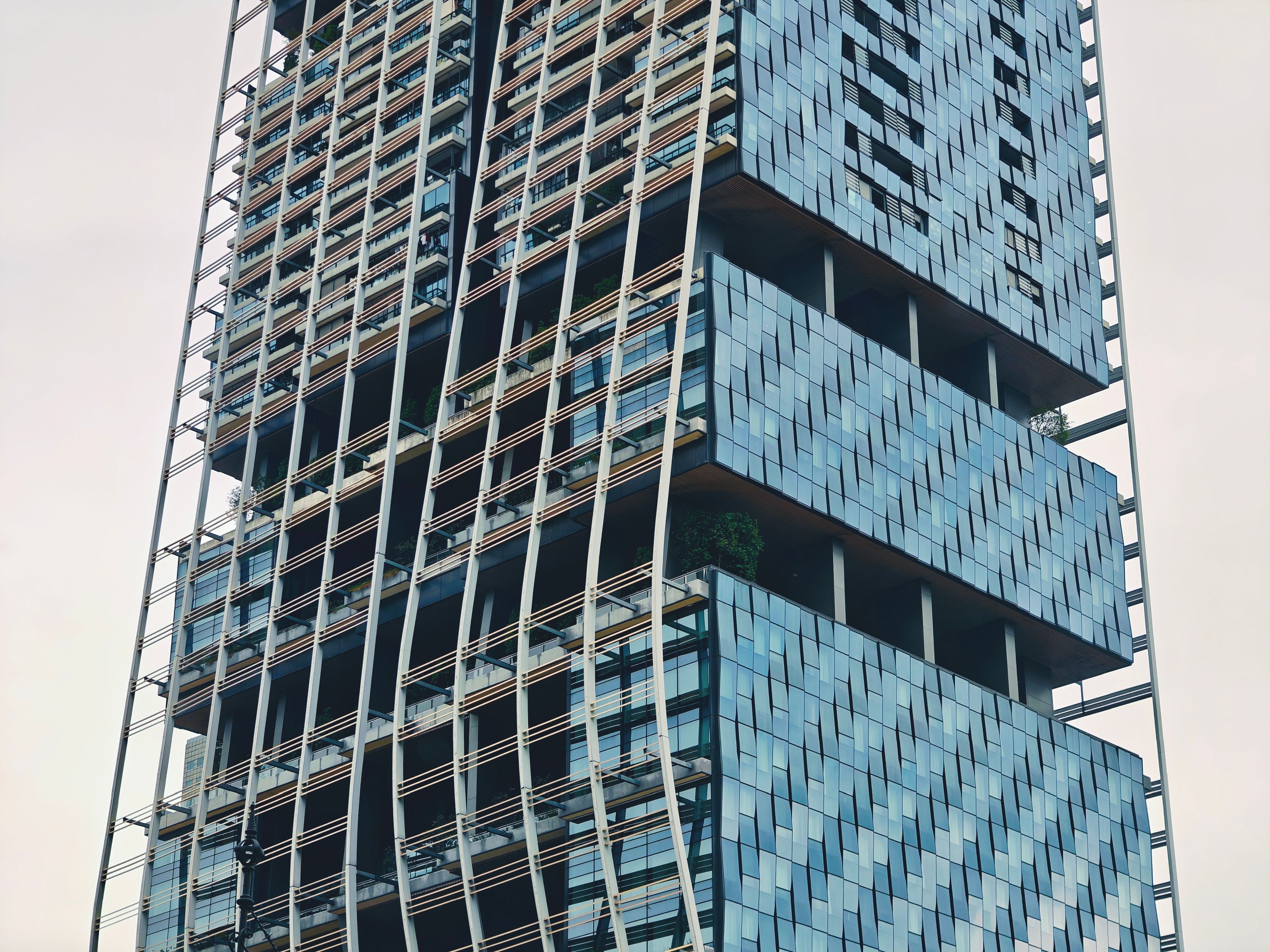 Close-up of a modern high-rise building showcasing innovative architecture in downtown Singapore.