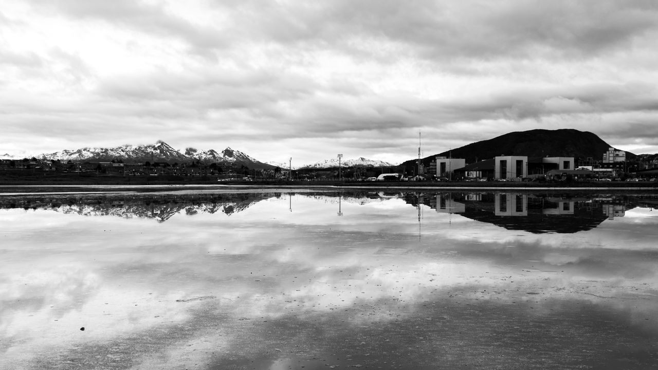 black and white landscape of ushuaia with mountain reflections in wate