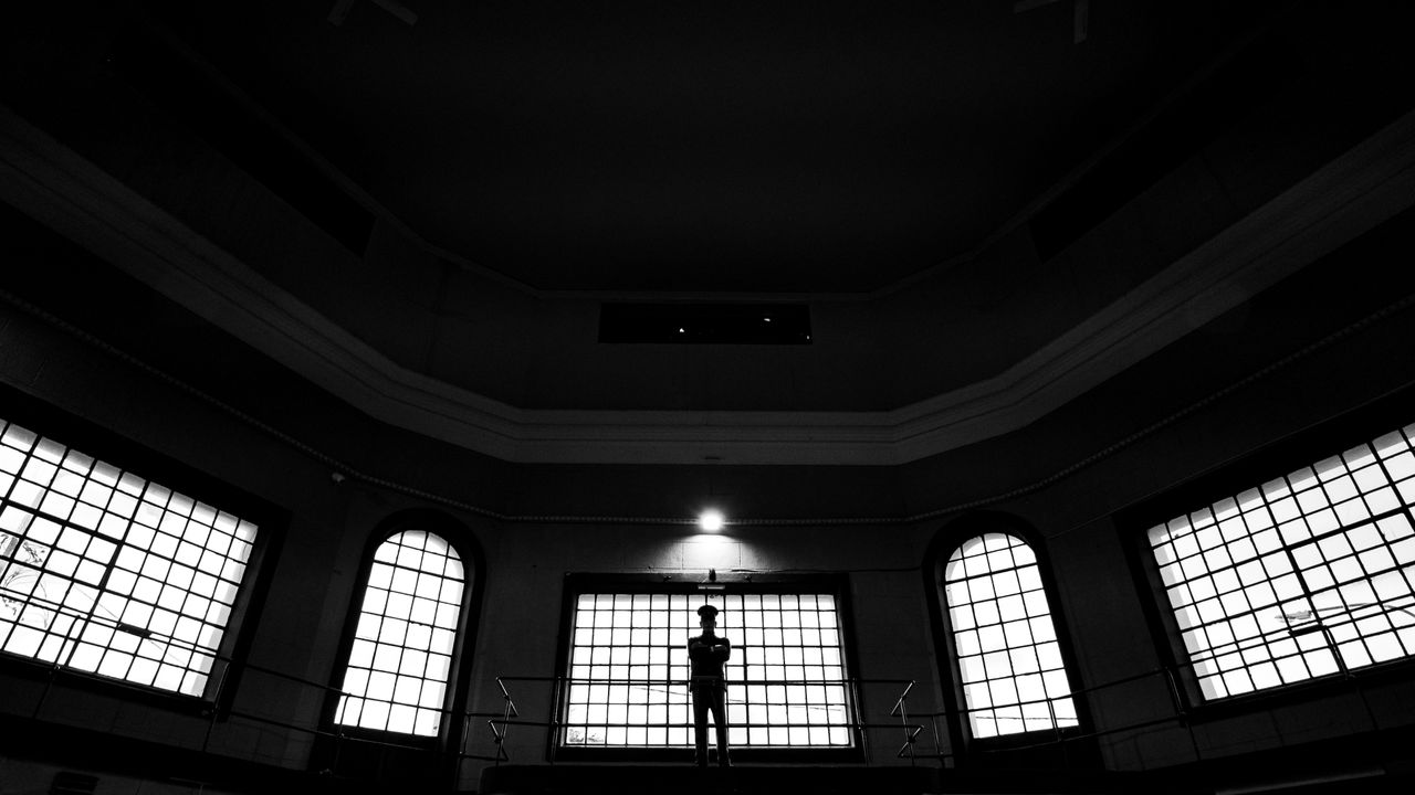 black and white photo of a silhouette inside a historic building in us