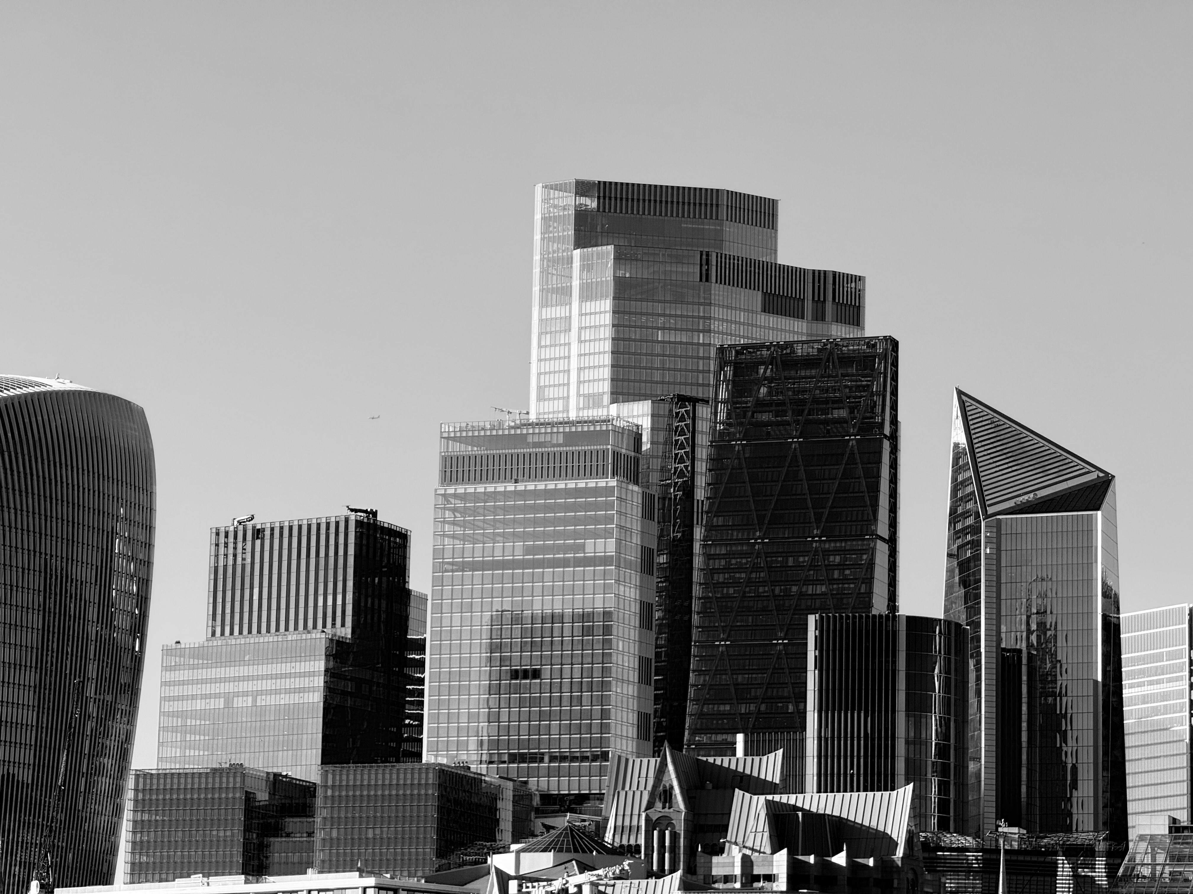Iconic skyscrapers of London's financial district captured in a classic black and white photograph.