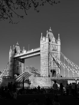 Stunning black and white photograph of the iconic Tower Bridge in London with silhouettes of people.