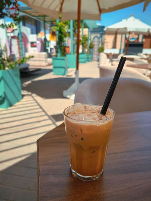 Free Refreshing iced coffee in a cozy outdoor café on a bright sunny day. Stock Photo