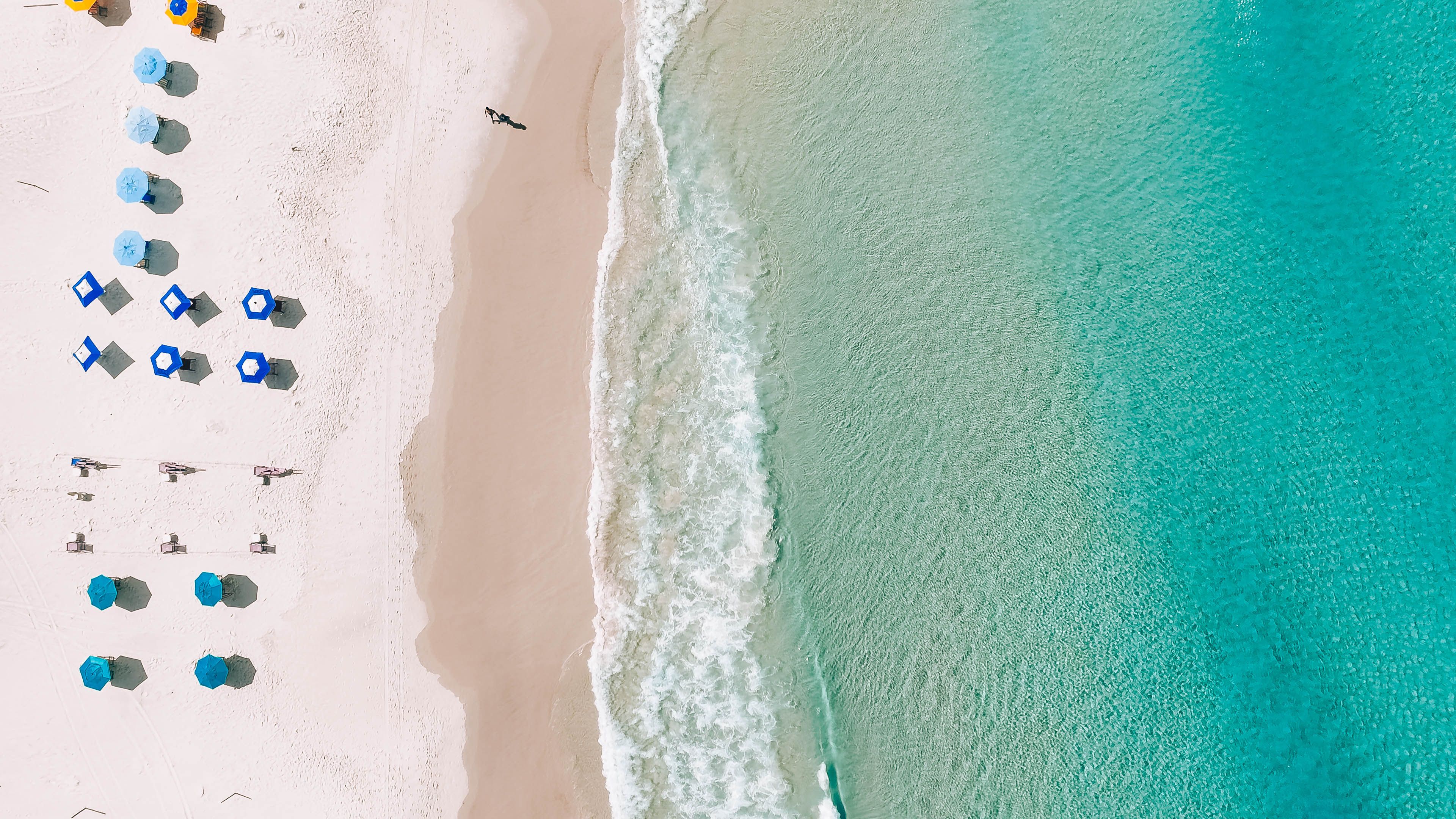 Aerial view of white sand beach and turquoise Gulf water along the Emerald Coast near Destin Florida