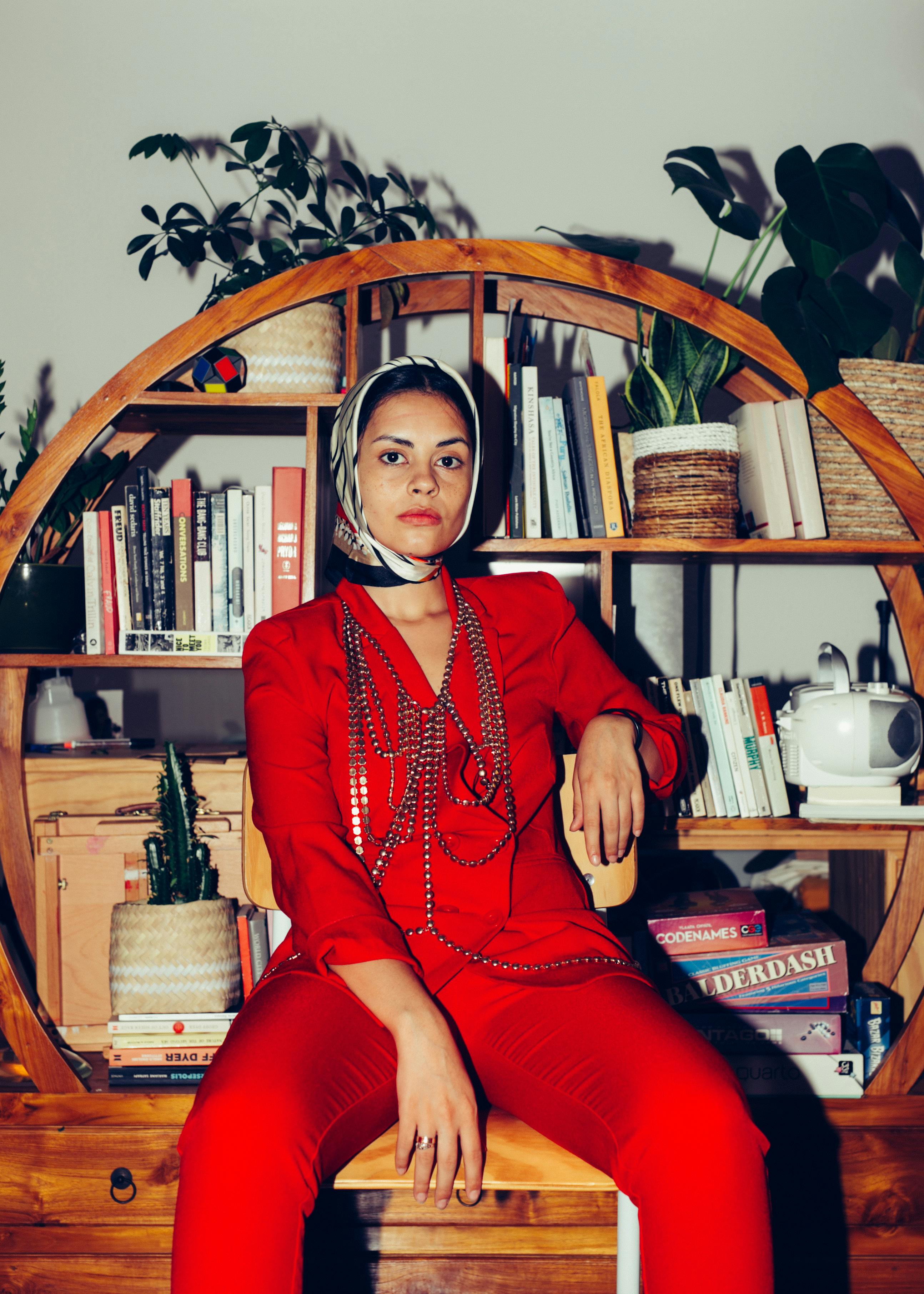 stylish ethnic woman in trendy outfit in living room