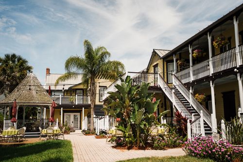 Free Charming courtyard with lush greenery and vibrant floral arrangements in historic St. Augustine, Florida. Stock Photo