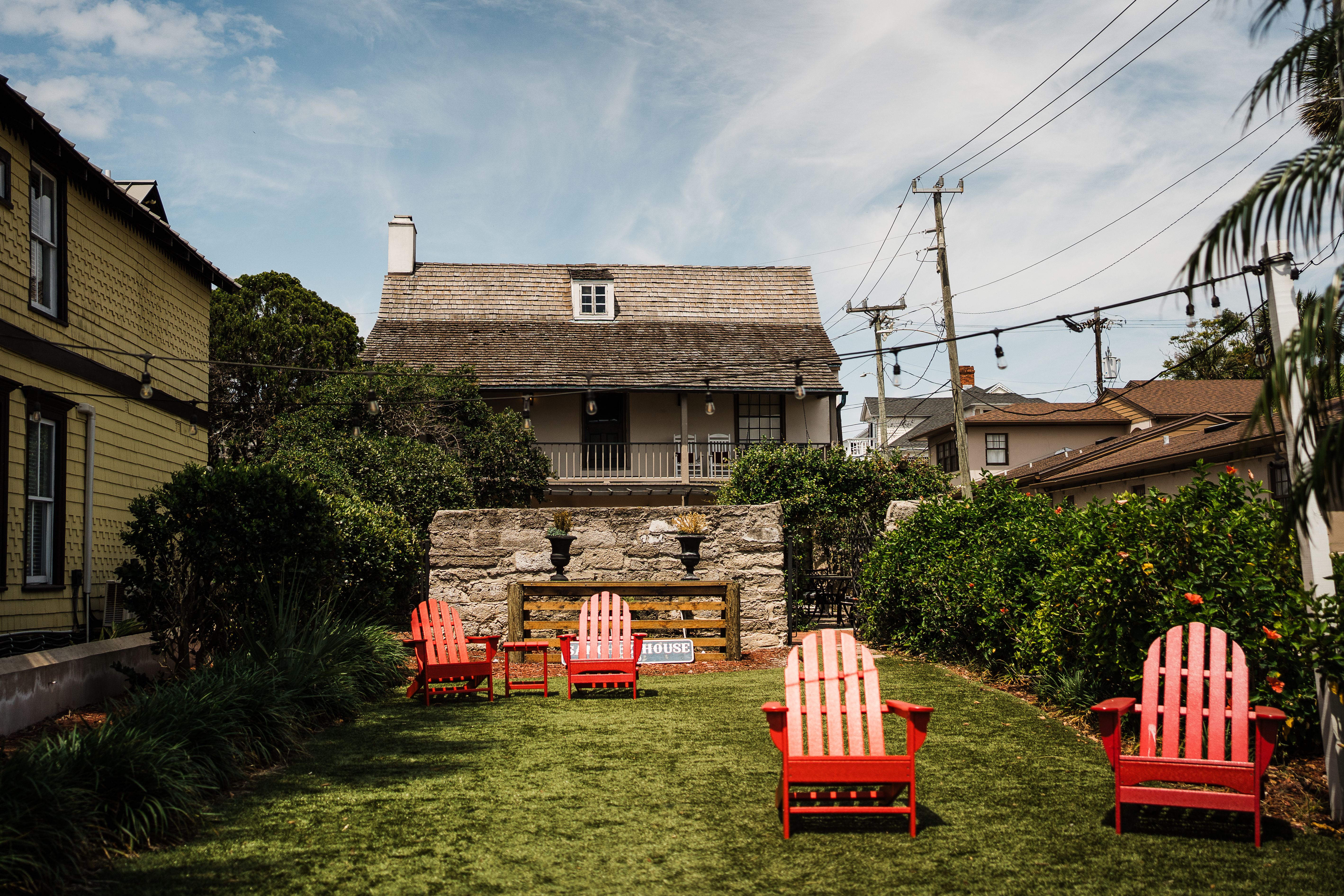 A tranquil courtyard with red chairs and historic architecture in St. Augustine, Florida.