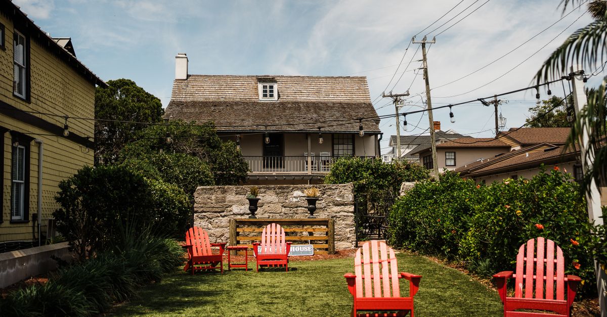 A tranquil courtyard with red chairs and historic architecture in St. Augustine, Florida.