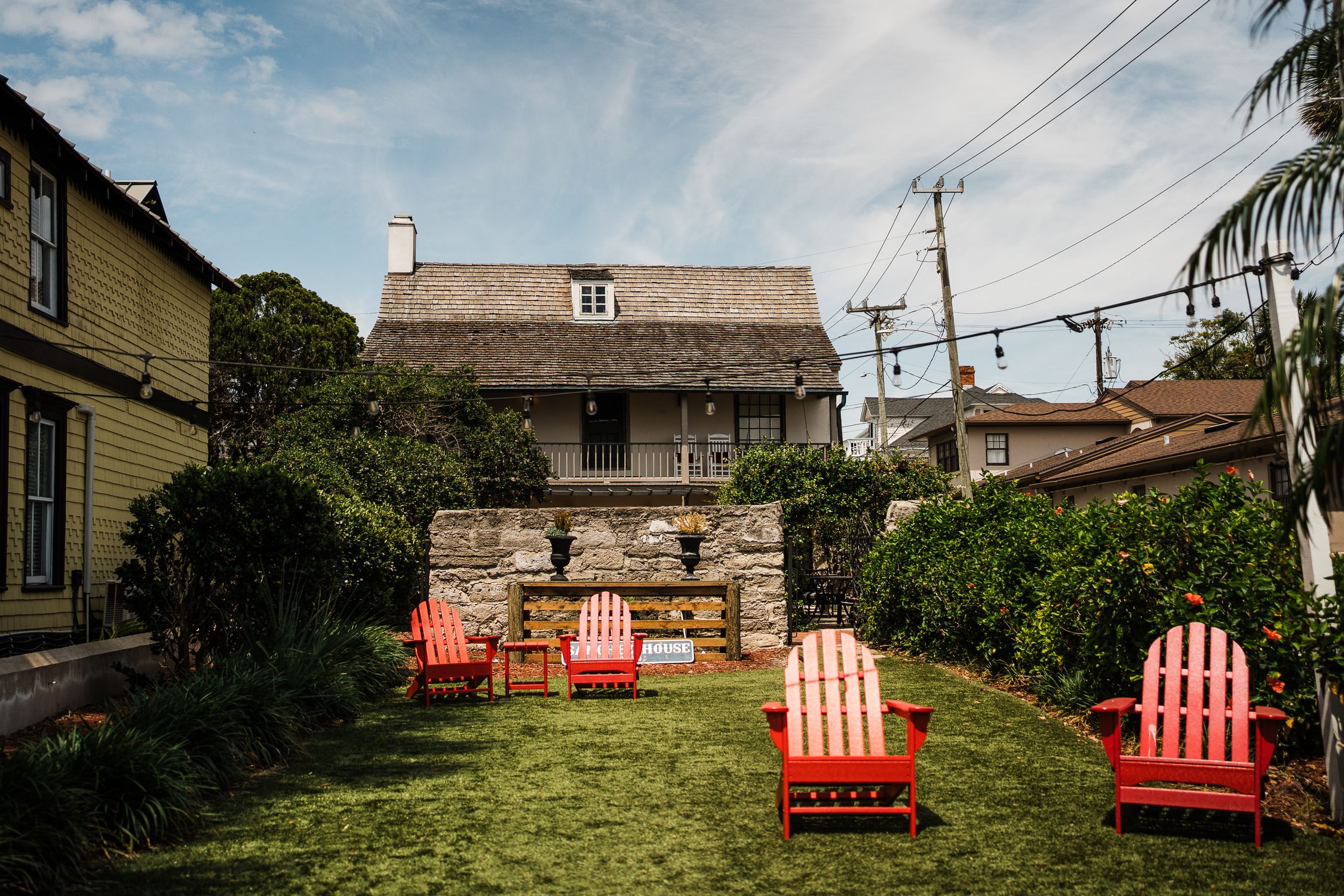 A tranquil courtyard with red chairs and historic architecture in St. Augustine, Florida.