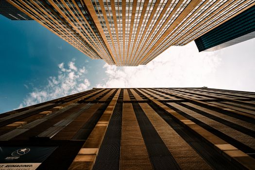 Dramatic upward view of skyscrapers against a blue sky in Minneapolis, Minnesota.