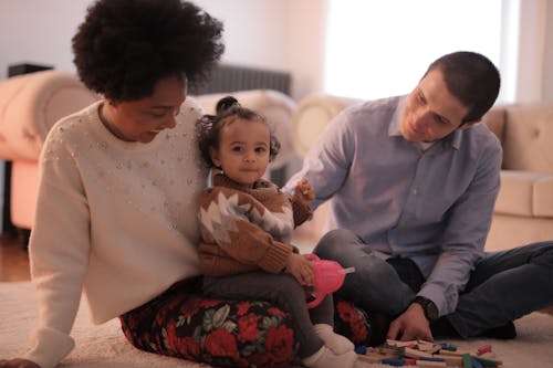 Free Photo of Kid Sitting on Her Mother's Lap Stock Photo