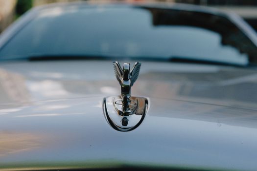 Elegant close-up of a chrome car hood ornament on a luxury vehicle, Kyiv, Ukraine.