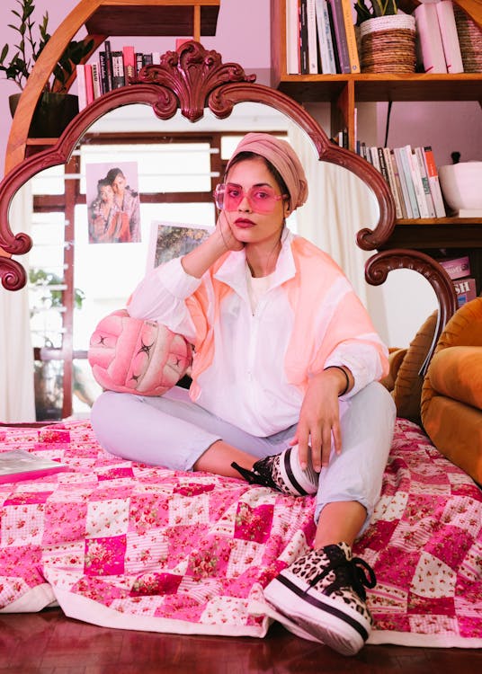 Woman Leaning on Ball While Sitting on Bed