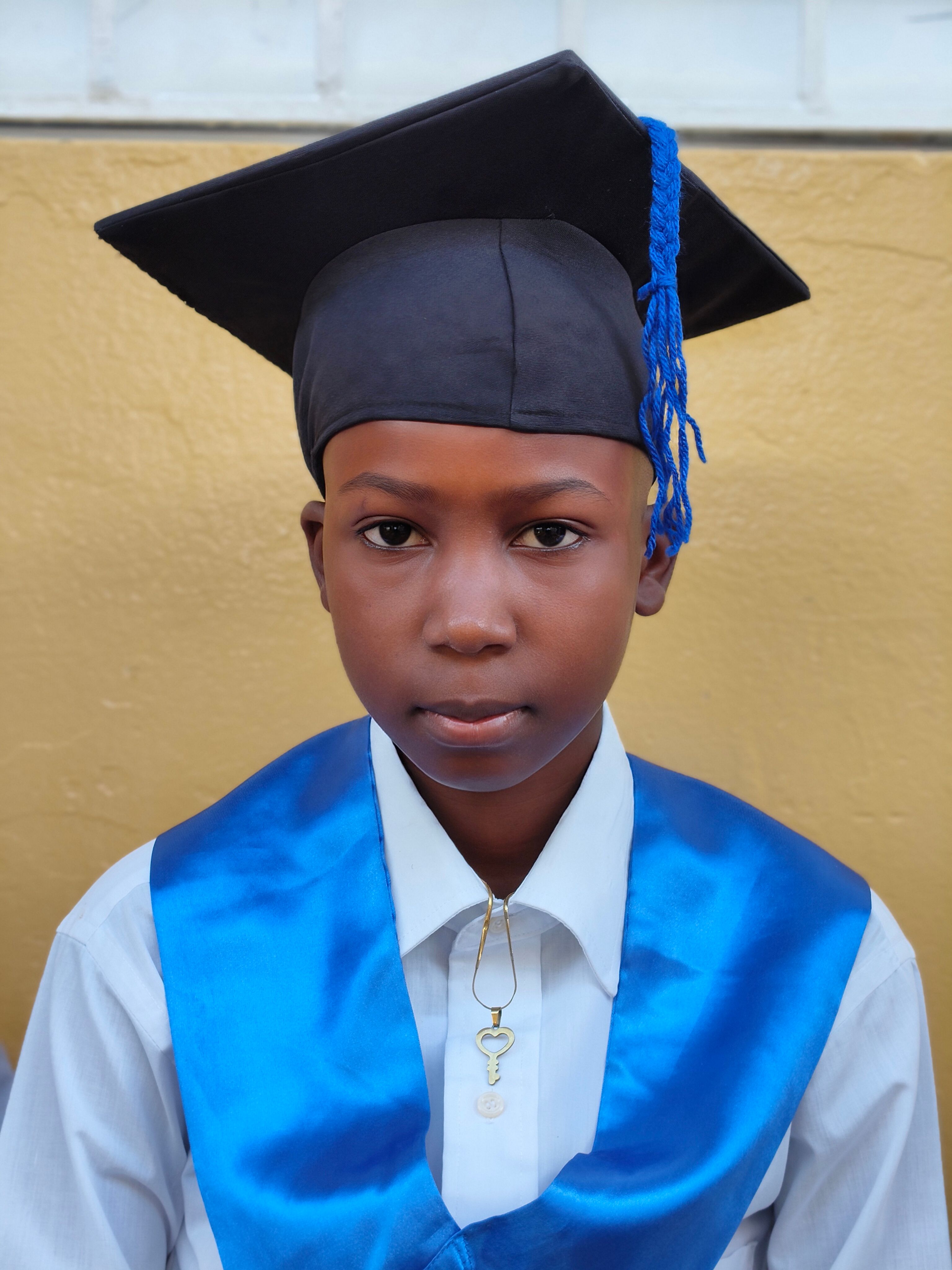 Portrait of a young graduate wearing a cap and gown, symbolizing academic achievement and future success.