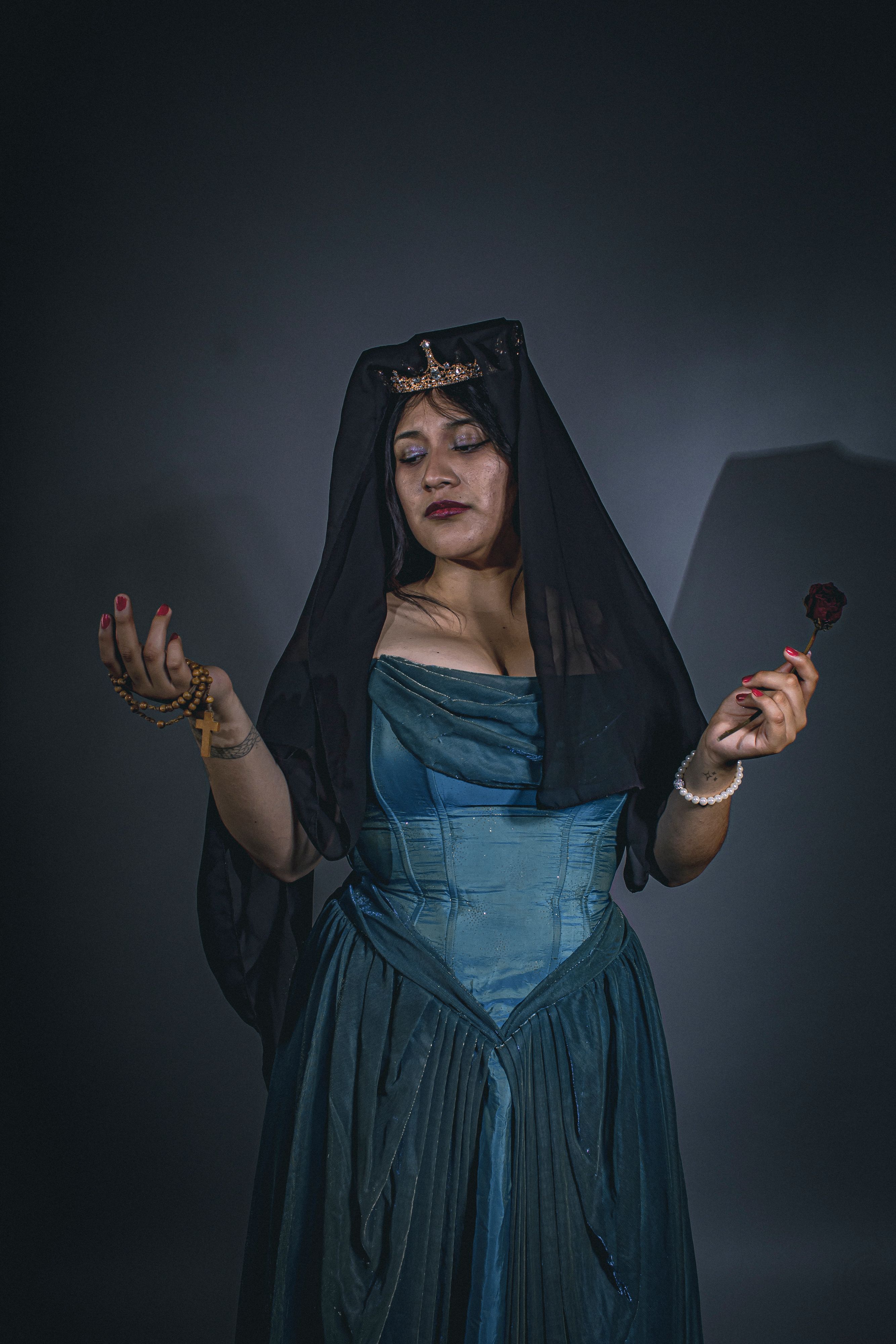 Dramatic portrait of a woman in a Victorian-style gown and veil, holding a rose.. dramatic, portrait, woman