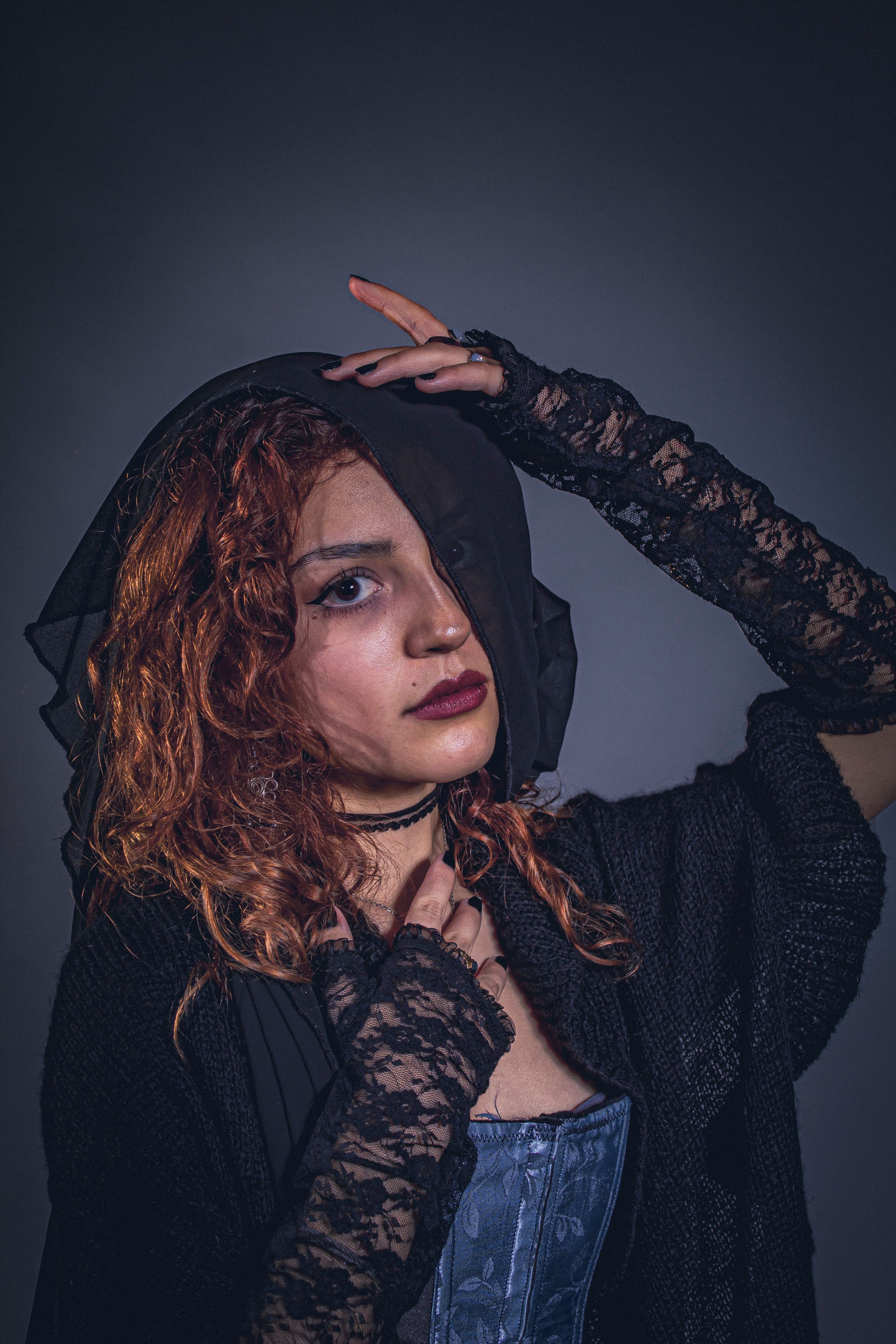 Dramatic portrait of a woman in Victorian-inspired attire with lace gloves.. dramatic, portrait, woman