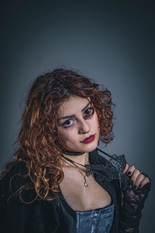 Free A captivating portrait of a woman in gothic-Victorian style with intricate lace details. Stock Photo