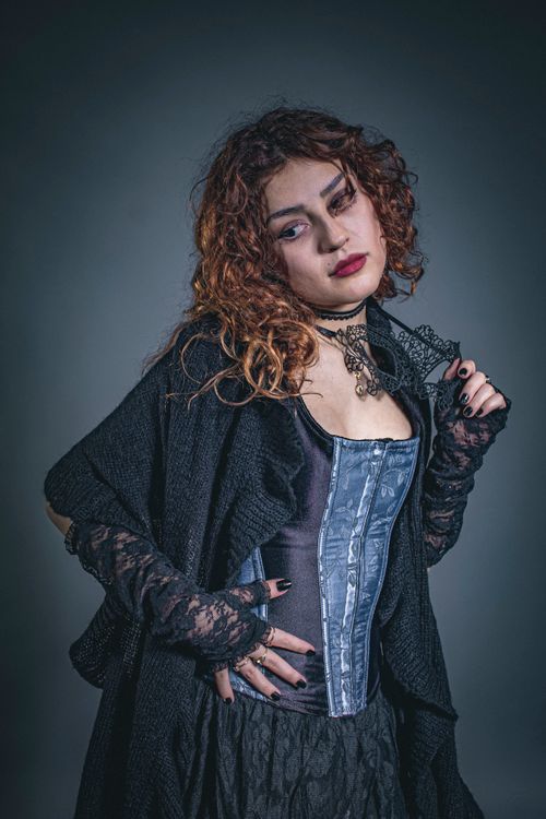 Free Elegant portrait of a young woman in Victorian-style fashion with curly hair. Stock Photo