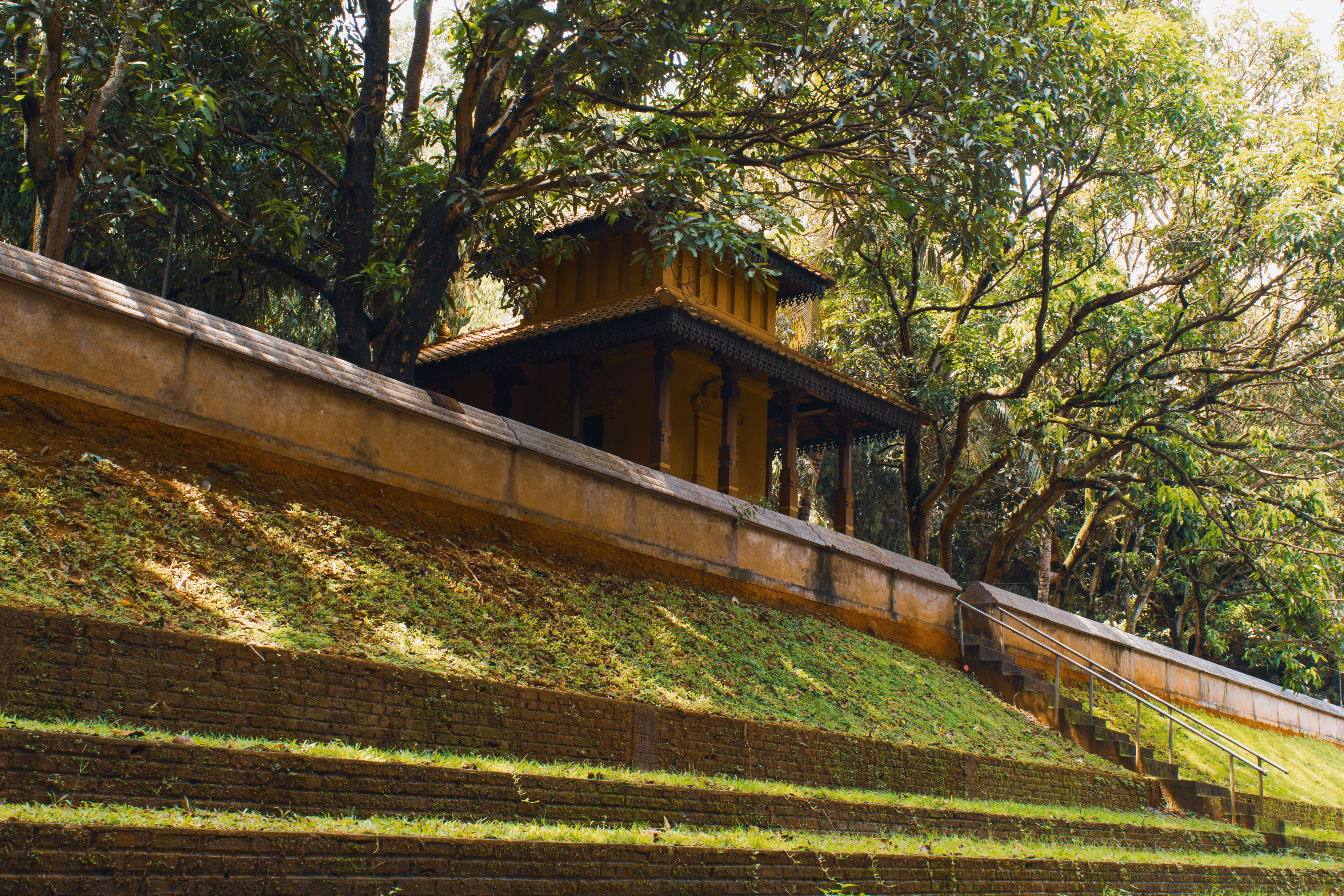 A peaceful pavilion surrounded by lush greenery in Peliyagoda, Sri Lanka, showcasing nature's tranquility.