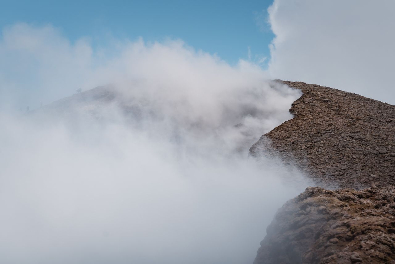 captivating view of a volcanic earth landscape enveloped in mist and s