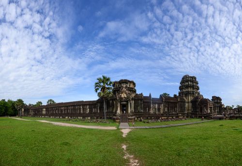 Free Wide-angle view of Angkor Wat temple under a vibrant sky in Cambodia, capturing its grandeur. Stock Photo