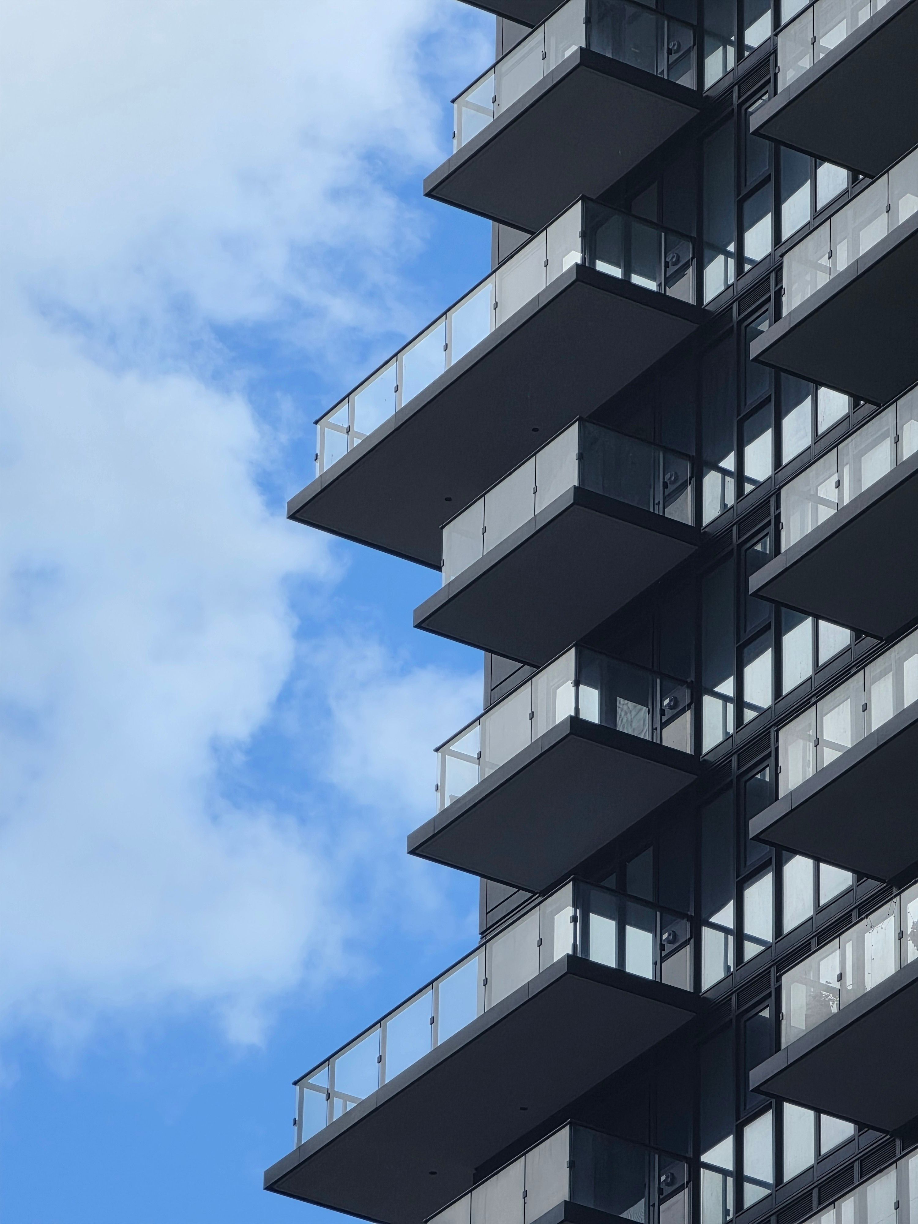 Balconies on a modern condominium building, representing the condo and townhome segment that held flat at a $290,000 median in Southern Nevada