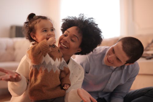 Free Photo of Man and Woman Having Fun With Their Child Stock Photo
