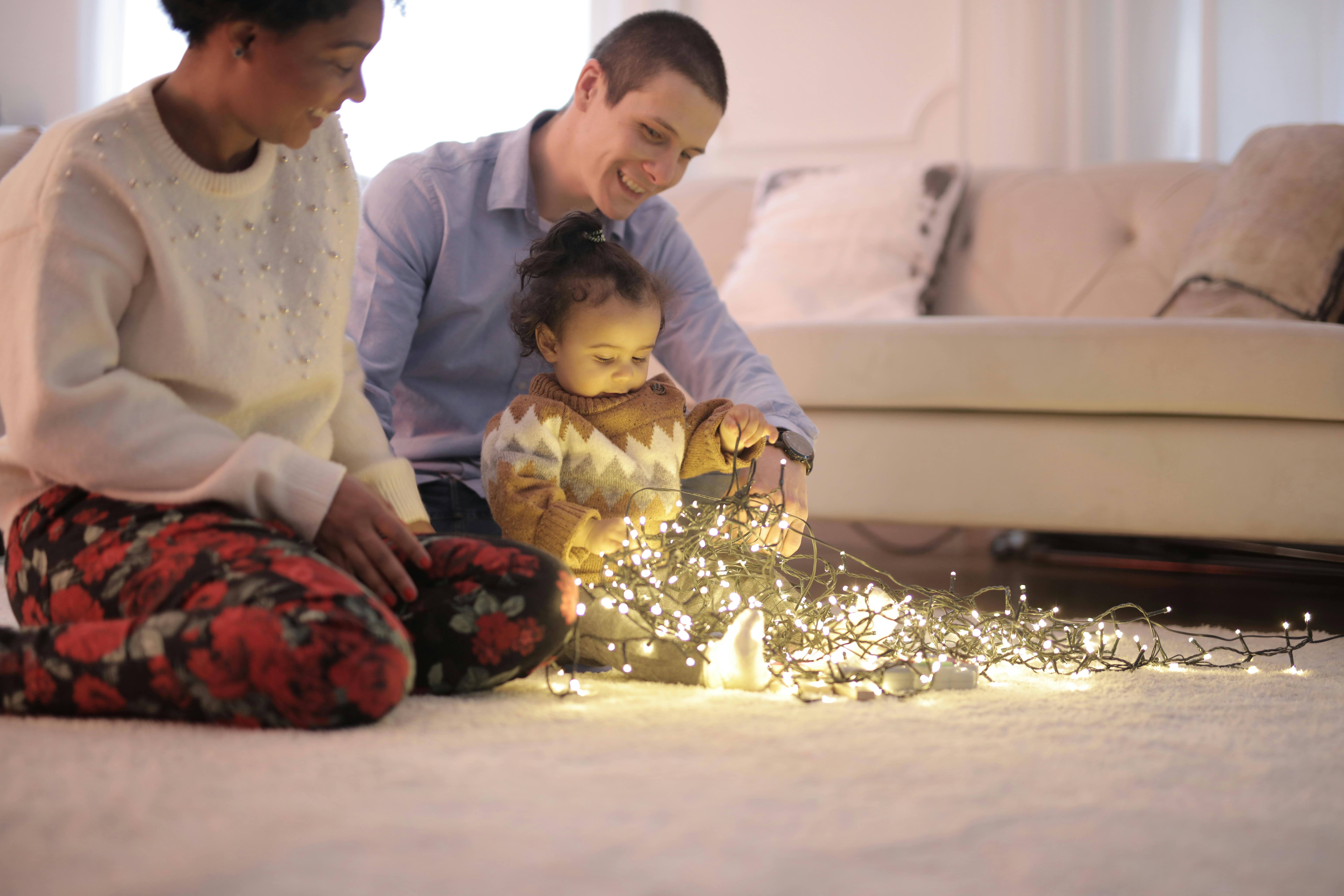 photo of kid playing with string lights