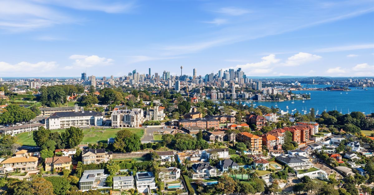 Beautiful aerial view of Sydney's skyline and harbor on a sunny day.