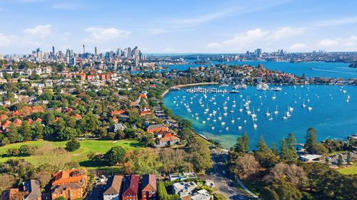 Free Breathtaking aerial view of Sydney with harbor, cityscape, and greenery. Stock Photo